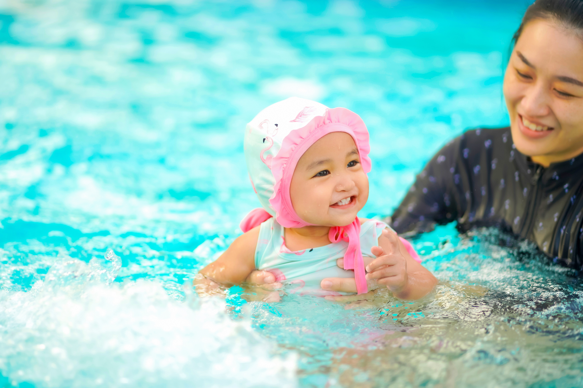 Baby having swim lesson in pool